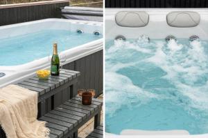 a hot tub with a bottle of champagne and a bottle of wine at 1157-Ringkobing-Frans-Julius-Vej-7 in Klegod