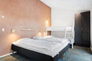 a bedroom with two bunk beds and a ladder at 1157-Ringkobing-Frans-Julius-Vej-7 in Klegod +33 photos