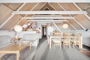 a living room with a table and chairs at 2254-Ringkobing-Nordso-Ferievej-52 in Nørre Lyngvig