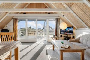a living room with a couch and a tv at 2254-Ringkobing-Nordso-Ferievej-52 in Nørre Lyngvig