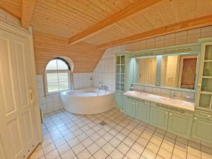 a large bathroom with a tub and a sink at 152-Ringkobing-Regnspovedalen-6 in Nørby +29 photos