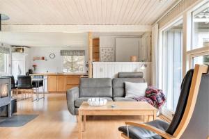 a living room with a couch and a table at 095-Ringkobing-Risbjergvej-12 in Nørby