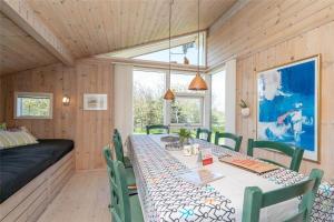 a dining room with a long table and chairs at 078-Ringkobing-Rorsangervej-11 in Nørby +25 photos