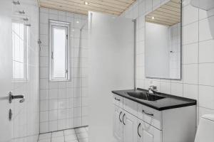 a white bathroom with a sink and a toilet at 265-Ringkobing-Klitsvinget-5 in Klegod +14 photos