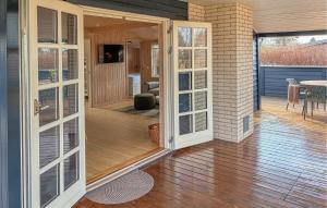 an open door to a patio with a table at 2 Bedroom Amazing Home In Slagelse in Slagelse +17 photos