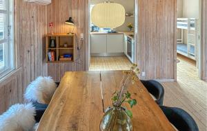 a wooden table in a room with two dogs at 2 Bedroom Amazing Home In Slagelse in Slagelse