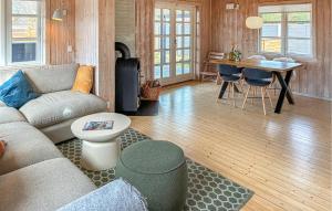 a living room with a couch and a table at 2 Bedroom Amazing Home In Slagelse in Slagelse