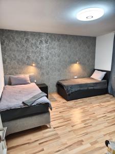 a bedroom with two beds and a wooden floor at Schöne Wohnung Prima am Bahnhof Schwerte in Schwerte