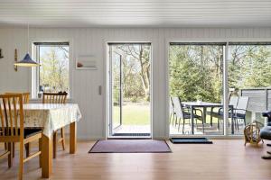 a kitchen and dining room with sliding glass doors at 127-Ringkobing-Birkealle-1 in Nørby
