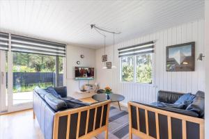 a living room with two couches and a table at 233-Ringkobing-Milevej-38 in Klegod
