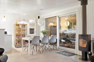a living room with a dining room table and chairs at 278-Ringkobing-Fladsbjergvej-54 in Klegod +21 photos