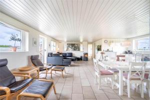 a living room with a table and chairs at 286-Ringkobing-Vestklitvej-14 in Klegod