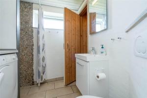 a bathroom with a toilet and a sink at 286-Ringkobing-Vestklitvej-14 in Klegod +30 photos