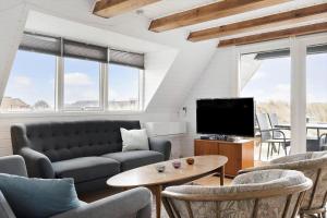 a living room with a couch and a tv at 260-Ringkobing-Vestklitvej-13 in Klegod
