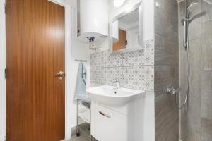 a small bathroom with a sink and a shower at 260-Ringkobing-Vestklitvej-13 in Klegod +35 photos