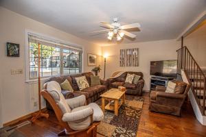 a living room with a couch and chairs and a tv at Lake Forest Glen # 142 in Tahoe City