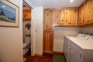 a small bathroom with a washer and dryer at Lake Forest Glen # 142 in Tahoe City +24 photos