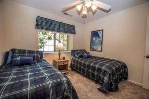 a bedroom with two beds and a window at Lake Forest Glen # 142 in Tahoe City