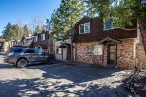 a car parked in front of a brick house at Lake Forest Glen # 142 in Tahoe City