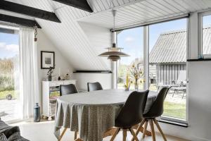 a dining room with a table and some chairs at 273-Ringkobing-Nordso-Ferievej-28 in Nørre Lyngvig