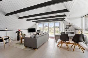 a living room with a couch and a table at 273-Ringkobing-Nordso-Ferievej-28 in Nørre Lyngvig