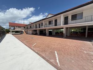 an empty parking lot in front of a building at Surf Beach Motel Tweed in Tweed Heads