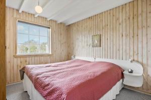 a bedroom with a bed and a window at 1101-Ringkobing-Rorsangervej-8 in Nørby