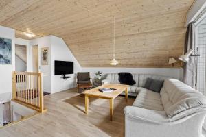 a living room with a couch and a table at 1101-Ringkobing-Rorsangervej-8 in Nørby