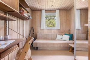 a small living room with a couch and a window at 1082-Ringkobing-Milevej-11 in Klegod