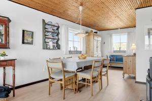 a kitchen and dining room with a table and chairs at 179-Ringkobing-Nordsovej-236 in Søndervig