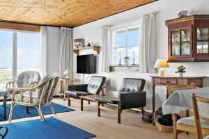 a living room with chairs and a table at 179-Ringkobing-Nordsovej-236 in Søndervig