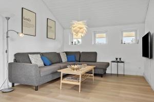a living room with a couch and a table at 232-Ringkobing-Jakob-Bondes-Vej-35 in Klegod