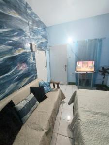 a living room with a couch and a painting on the wall at Powell's guesthouse in Santa Cruz