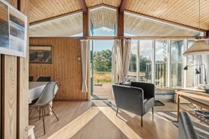a living room with a table and chairs in a room at 201-Ringkobing-Fladsbjergvej-234 in Klegod