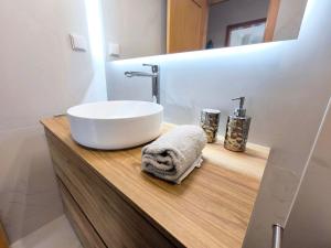 a bathroom with a white sink and a mirror at Seaview Varandas do Sol 2 in Portimão +22 photos