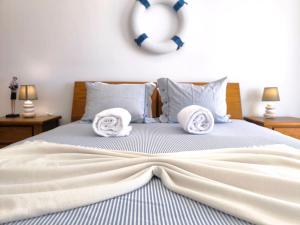 a bedroom with a bed with towels on it at Seaview Varandas do Sol 2 in Portimão