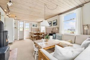 a living room with a couch and a table at 1165-Ringkobing-Lodbergsvej-119 in Søndervig