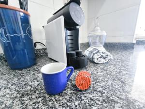 a coffee maker and a coffee cup on a counter at Seaview Varandas do Sol 2 in Portimão