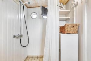 a shower with a shower curtain in a bathroom at 1165-Ringkobing-Lodbergsvej-119 in Søndervig +25 photos