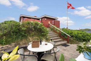 a table and chairs with a table and a flag at 1165-Ringkobing-Lodbergsvej-119 in Søndervig