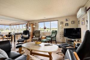 a living room with a table and chairs at 268-Ringkobing-Lyngvejen-63 in Klegod