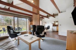 a living room with chairs and a table at 113-Ringkobing-Ahornalle-16 in Nørby