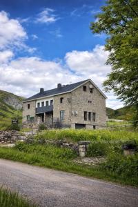 an old stone house on the side of a road at Coronel Somiedo by Unusual Hotels in El Puerto de Somiedo