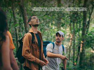 two men walking through a forest with a quote at Reserva Natural Iguazú - Pristine Luxury Camp in Puerto Libertad