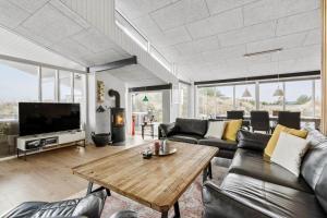 a living room with a couch and a coffee table at 1149-Ringkobing-Holmsborgvej-32 in Søndervig