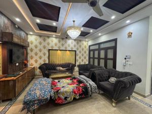 a living room with a couch and a tv at 6-BedRoom house in Bahria in Lahore