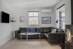 a living room with a couch and a table at 1102-Ringkobing-Gransangervej-14 in Nørby