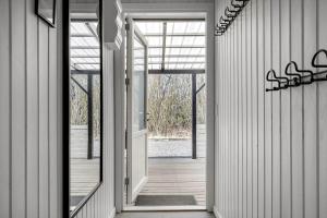 an open door of a house with a wooden hallway at 1102-Ringkobing-Gransangervej-14 in Nørby