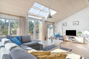 a living room with a couch and a table at 2202-Ringkobing-Lyngvejen-73 in Klegod