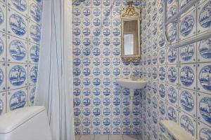 a blue and white bathroom with a sink and a mirror at 2202-Ringkobing-Lyngvejen-73 in Klegod +30 photos
